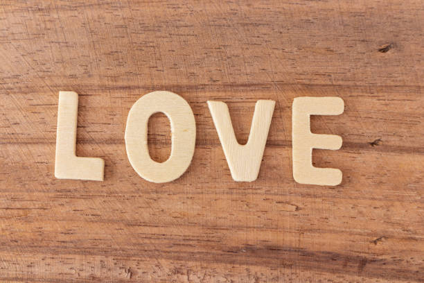 istock Love wooden text on board background. 1200658566