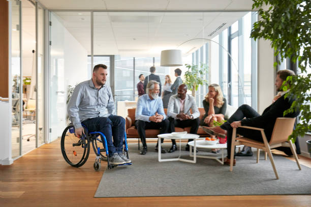 istock Young Casual Businessman Wheeling Through Office Lobby 1200658847