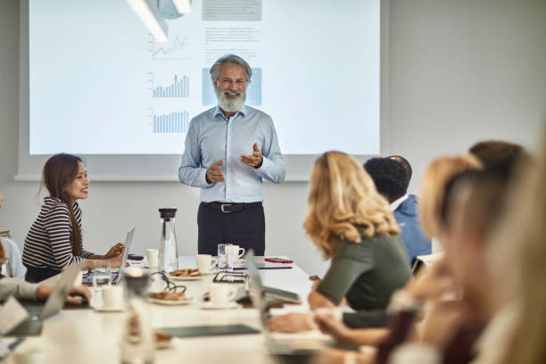 istock Mature Businessman Making Presentation to Executive Team 1200658867