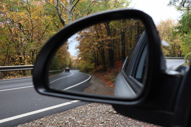 istock car mirror , autumn season forest road 1200660912