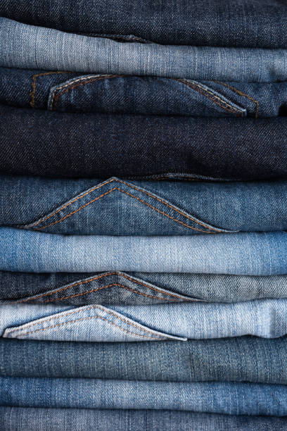 istock Stack of blue jeans of different shades. Jeans background. Close-up 1200661885