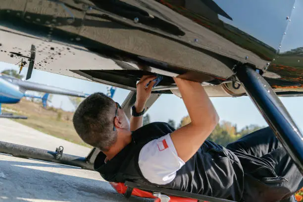 Photo of Mechanic cleaning the helicopter engine