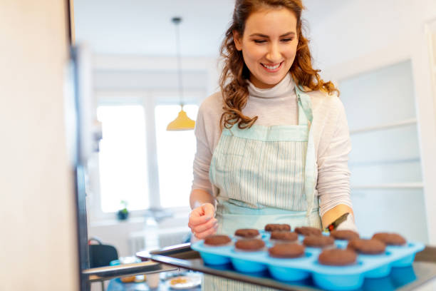 istock Woman in apron baking muffines 1200662058