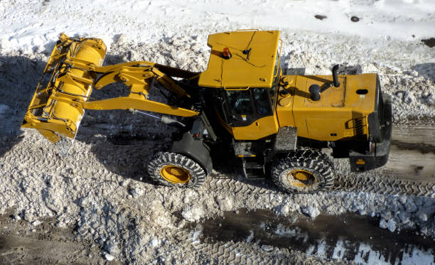 istock Big yellow tractor cleaning road 1200664472