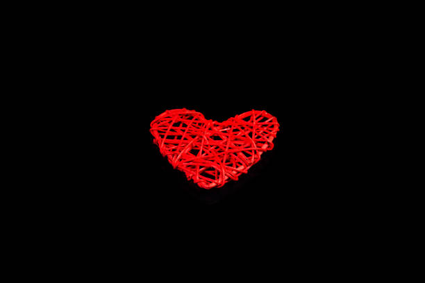 istock Red heart isolated on a black background. 1200666350