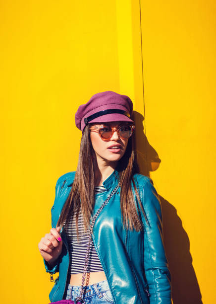 istock Young beautiful woman on yellow background 1200670811