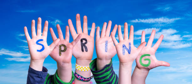 istock Children Hands Building Word Spring, Blue Sky 1200674725