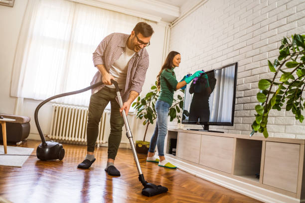 istock Couple cleaning their home 1200677497