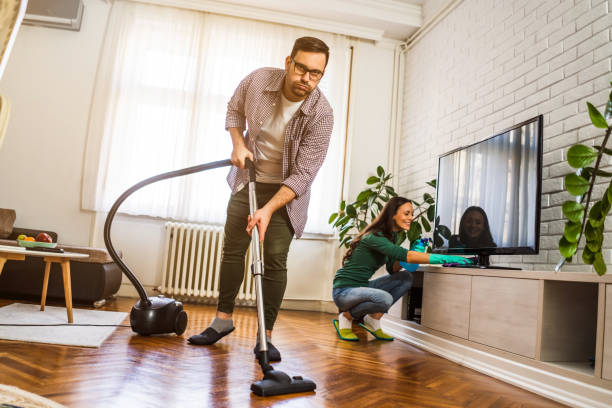 istock Couple cleaning their home 1200677614