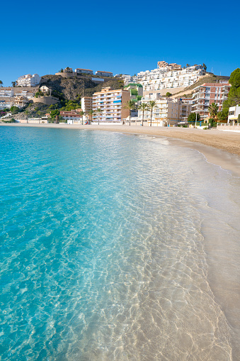 Ghadira Bay with sandy beach and sun umbrellas. Mellieha coastal town in the summer Malta aerial.