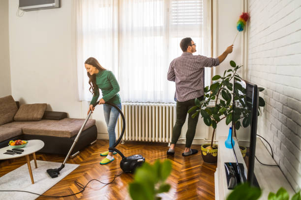 Couple cleaning their home stock photo