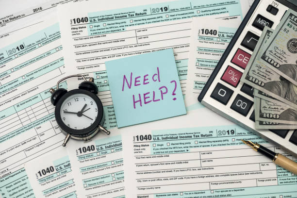 istock 1040 tax form in office with need help text 1200679020