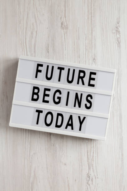 istock 'Future begins today' words on a modern board on a white wooden surface, top view. Overhead, from above, flat lay. 1200679376