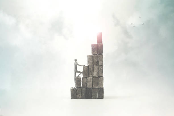 istock man climbing steep tower to reach the top 1200679474