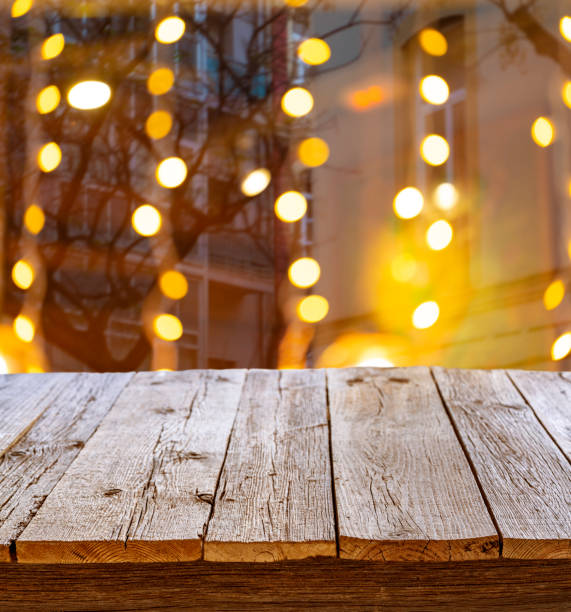 istock Rustic wooden table in party holidays blur lights 1200680432