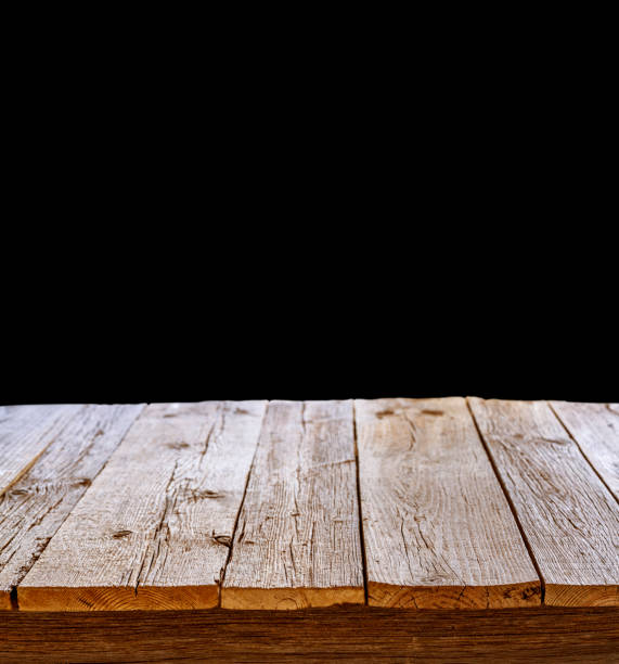 istock wooden table perspective with black wall background 1200680642