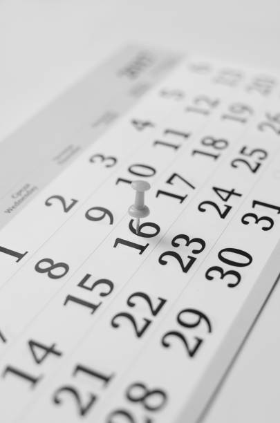 istock Black and white monthly calendar on table with office supplies 1200681812