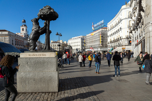 Madrid, Spain - January 22, 2018:  Statue of the Bear and the Strawberry Tree at Puerta del Sol in Madrid, Spain