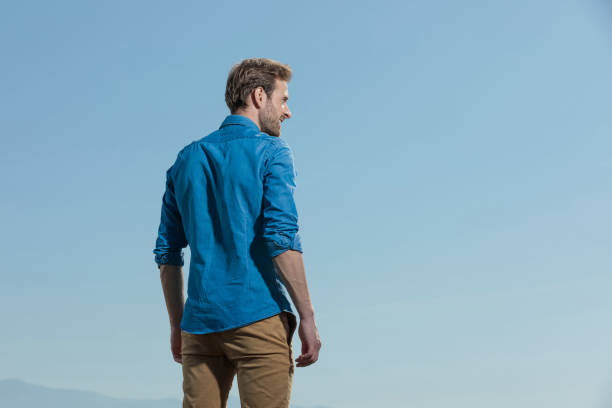 istock casual man standing relaxed with hands loose looking aside 1200682320