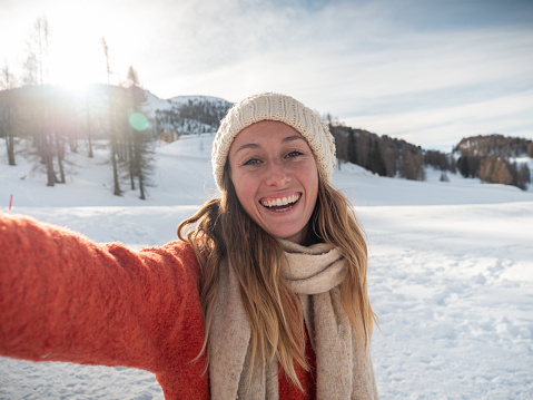 Young woman taking selfie in winter with snowcapped mountain view; people having fun in winter vacations
Switzerland Swiss Alps