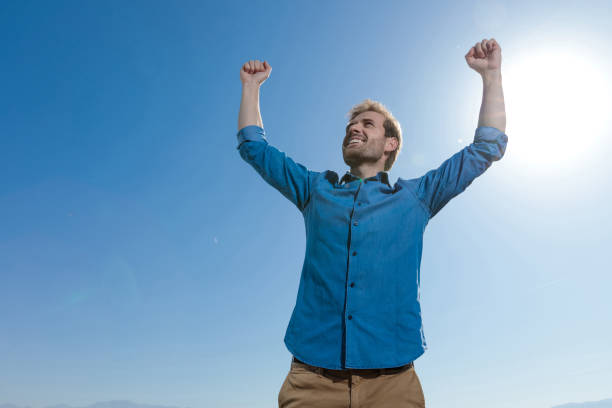 istock young casual man wearing blue shirt celebrating succes 1200682505