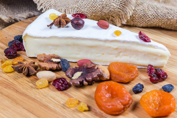 istock Brie cheese among nuts, dried fruits, closeup in selective focus 1200684028