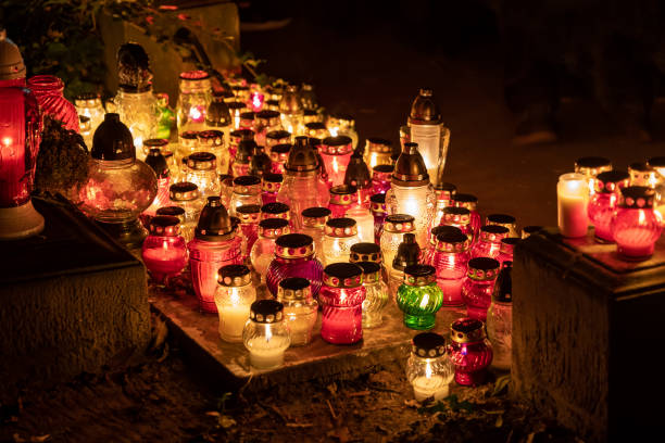 Candle grave lights at night in cemetery on the All Saints Day, Christian tradition.
