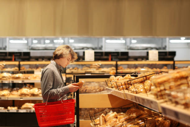 istock Teenager choosing bread  from a supermarket 1200686899