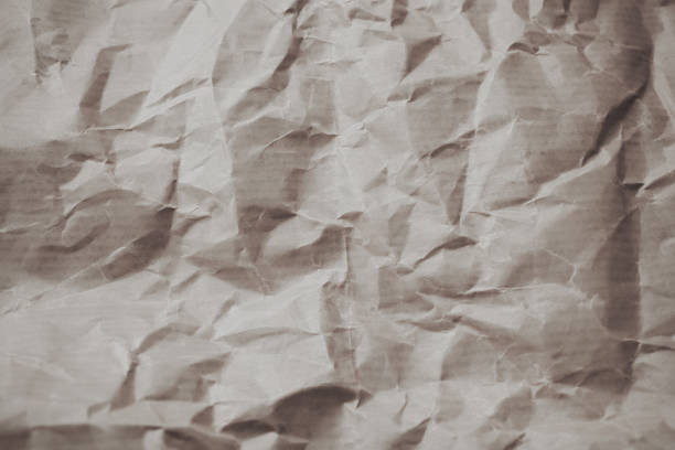 White rough crumpled paper as texture and background for design. Wrinkled paper texture. Abstract background for designers made with paper.