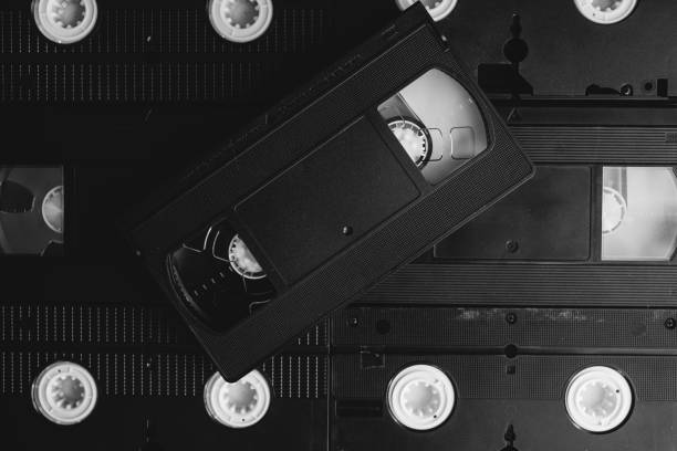 istock Stack of VHS video tapes as background. Old video cassette tapes. Retro technology. 1200687011