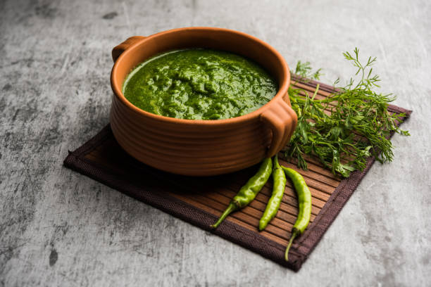 kothimbir or dhaniya chutney made using cilantro or coriander with chilli, served in a bowl. selective focus - chutney imagens e fotografias de stock