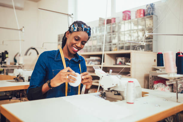istock Dressmaker woman working with sewing machine 1200687050