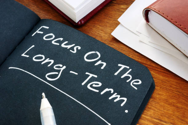 istock Focus on the long term written on the black page. 1200687530