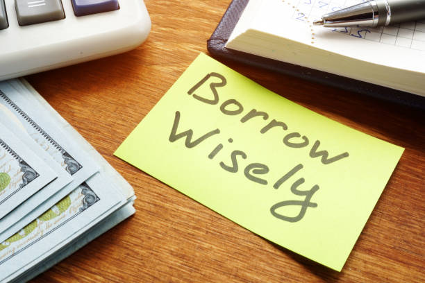istock Borrow Wisely sign and money. Choose loan concept. 1200687585