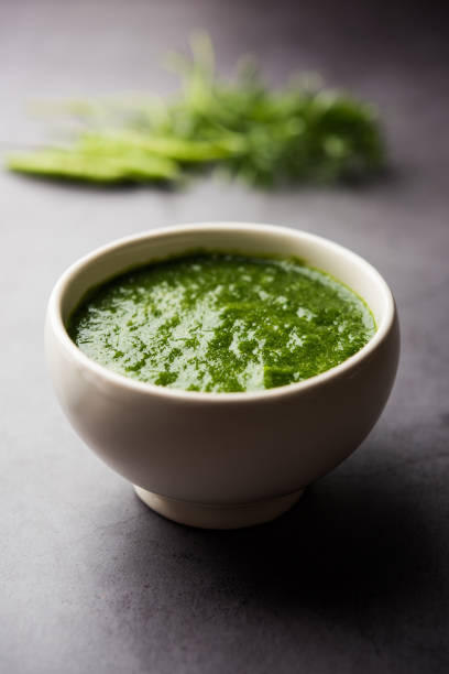 Kothimbir or Dhaniya Chutney made using Cilantro or coriander with chilli, served in a bowl. selective focus