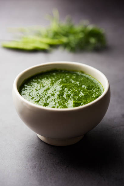Kothimbir or Dhaniya Chutney made using Cilantro or coriander with chilli, served in a bowl. selective focus stock photo
