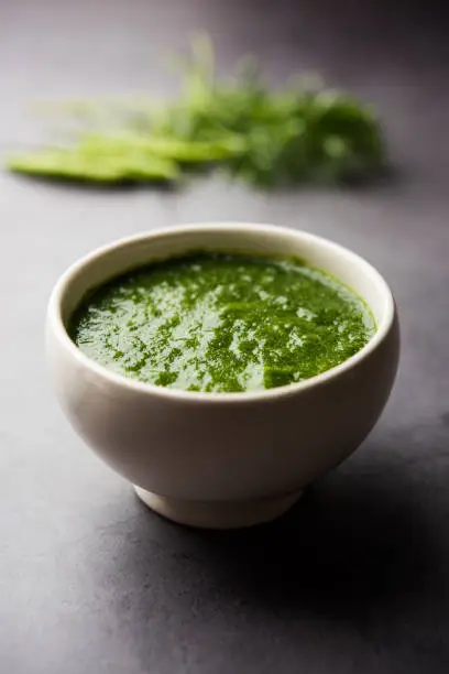 Kothimbir or Dhaniya Chutney made using Cilantro or coriander with chilli, served in a bowl. selective focus