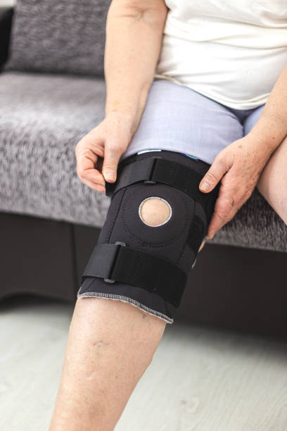 istock Person who puts on protective knee brace, knee support 1200688323