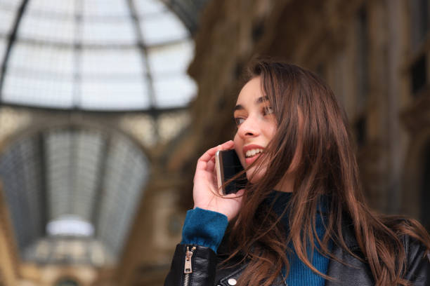 istock Happy woman talking on the phone 1200690819