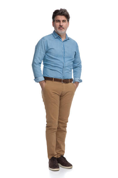 istock Confident casual man holding both hands in his pockets 1200692725