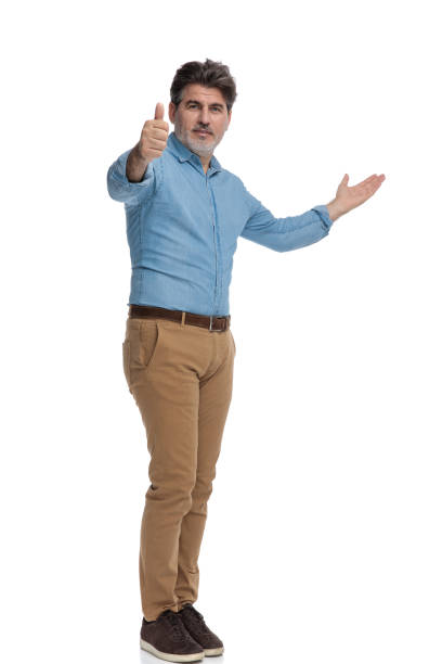 istock Succesful casual man giving a thumbs up and presenting 1200692820