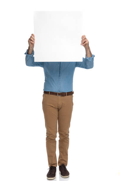 istock Old casual man holding an empty billboard over his face 1200692893