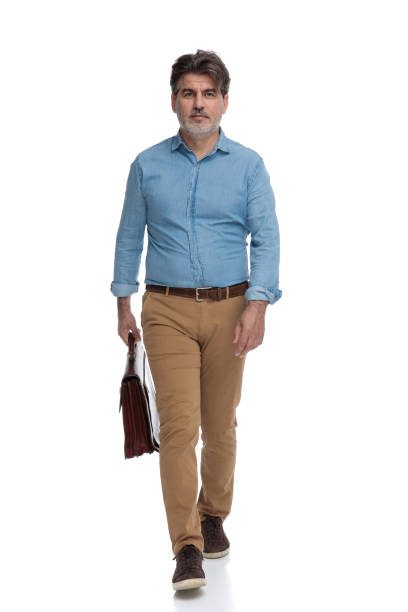 istock Motivated casual man holding his briefcase and walking 1200693474