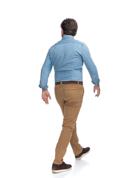 istock Rear view of a serious casual man walking 1200693526