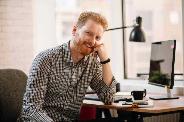 istock Young professional with cell phone in office 1200694946