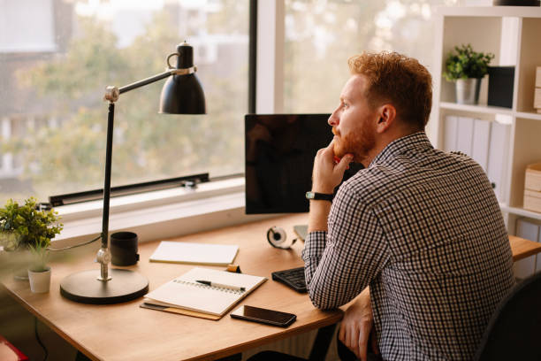 istock Young professional with cell phone in office 1200695146