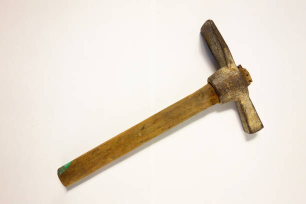 Miner hammer like pickaxe or mattock on white isolated background with shadow. Closeup view of rustic old hand tool for hard working to extract fossils or concept of block chain currency mining