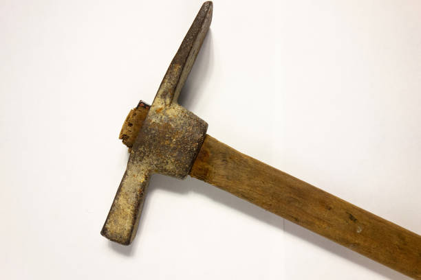 istock Miner hammer like pickaxe or mattock on white isolated background with shadow. Closeup view of rustic old hand tool for hard working to extract fossils or concept of block chain currency mining 1200695280