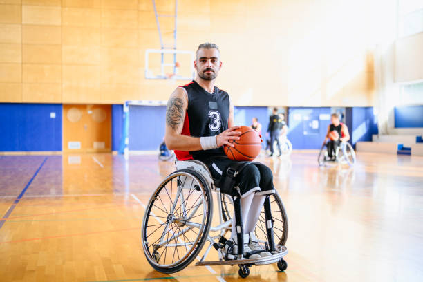 ritratto di giocatore di basket in carrozzina maschile con palla - basket su sedia a rotelle foto e immagini stock