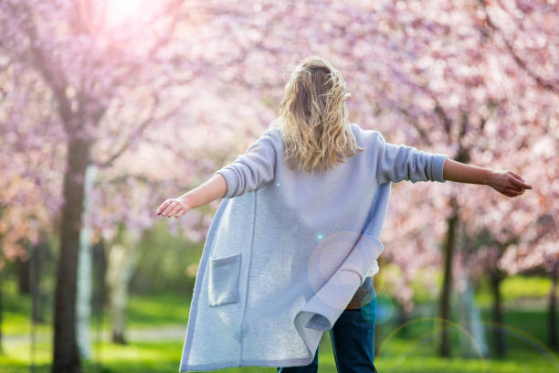 istock Dancing, running and whirling in beautiful park with cherry trees in bloom 1200696763